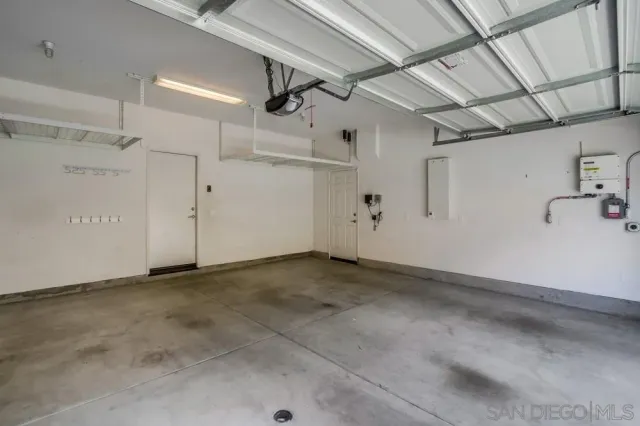 a view of a patio with a table and chairs under an umbrella