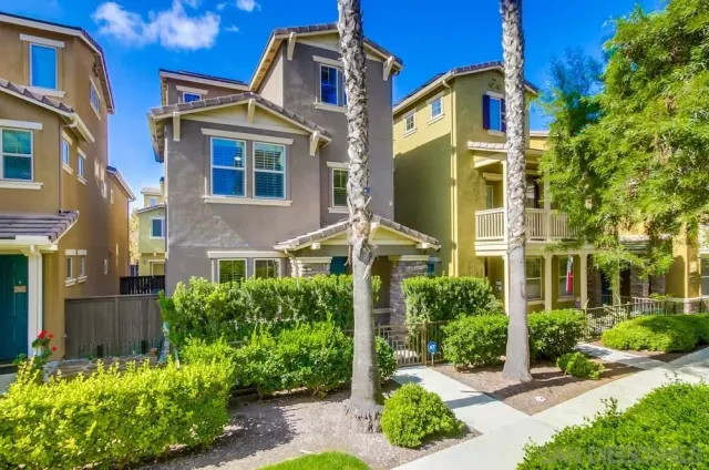 a view of a house with plants and a small yard