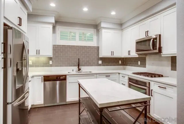 a kitchen with a stove a sink and a refrigerator