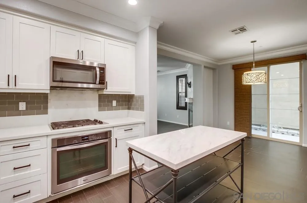 1859 Khaki Lane Chula Vista, CA 91913 - Photo 6 of 62 a kitchen with a stove and a microwave