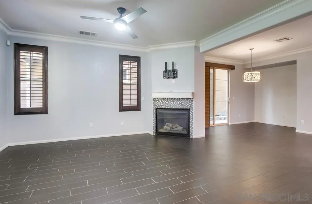 1859 Khaki Lane Chula Vista, CA 91913 - Photo 8 of 62 wooden floor fireplace and windows in an empty room