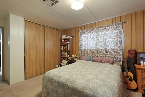 a bedroom with a bed and a window