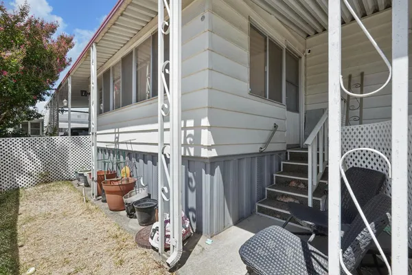 a balcony with table and chairs