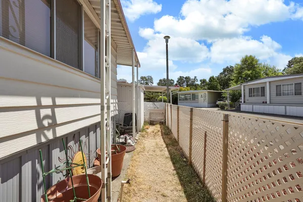 a view of balcony with wooden floor and fence