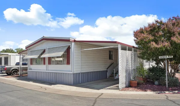 a view of a house with a backyard