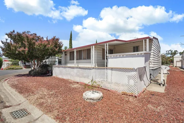 a view of a house with backyard and sitting area