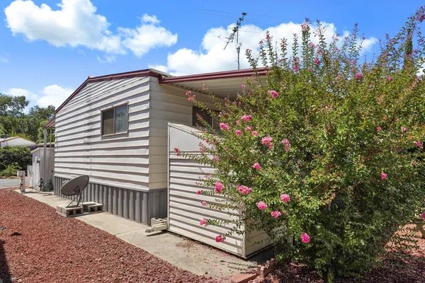 a view of a house with a flower garden