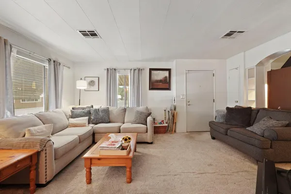 a living room with furniture and a large window