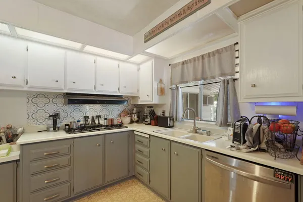 a kitchen with sink and cabinets