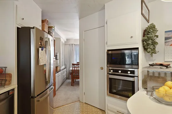 a kitchen with a refrigerator stove and microwave