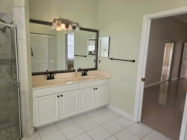 a bathroom with a double vanity sink and mirror