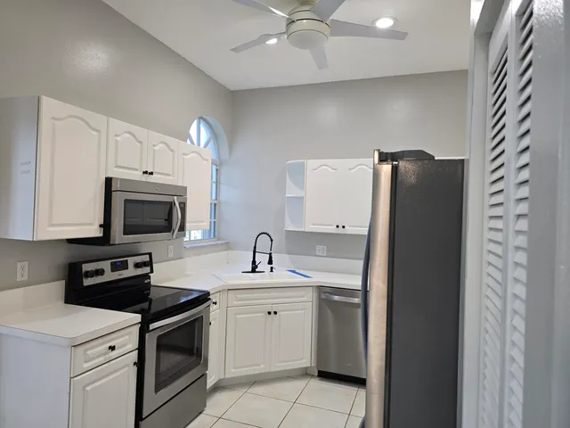 a kitchen with a sink stove and microwave