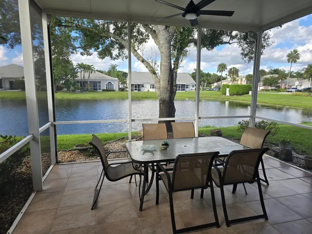 a view of an outdoor dining space with furniture and wooden floor