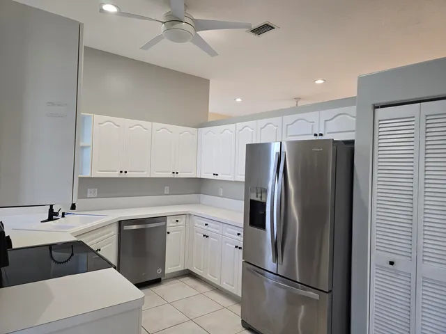 a kitchen with a sink stainless steel appliances and cabinets