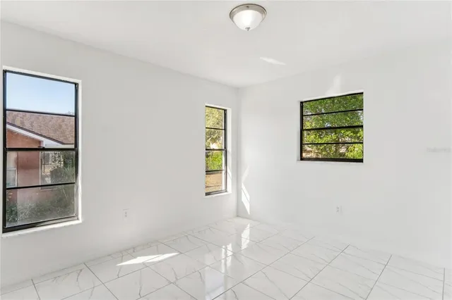 a bathroom with a granite countertop sink a toilet and shower