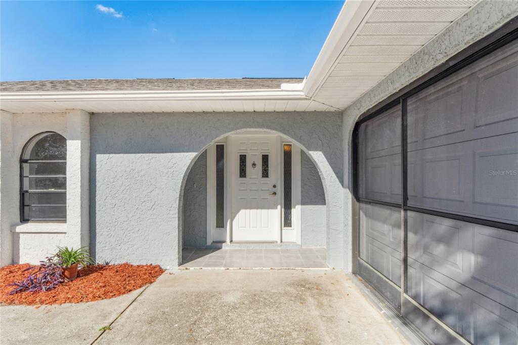 10237 Carrin Road Spring Hill, FL 34608 - Photo 2 of 39 a front view of a house with a garage
