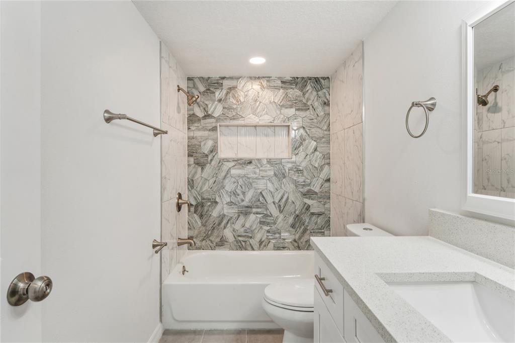 10237 Carrin Road Spring Hill, FL 34608 - Photo 23 of 39 a bathroom with a sink toilet and shower