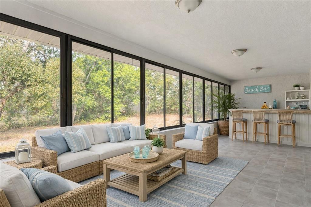 10237 Carrin Road Spring Hill, FL 34608 - Photo 26 of 39 a living room with furniture and a large window