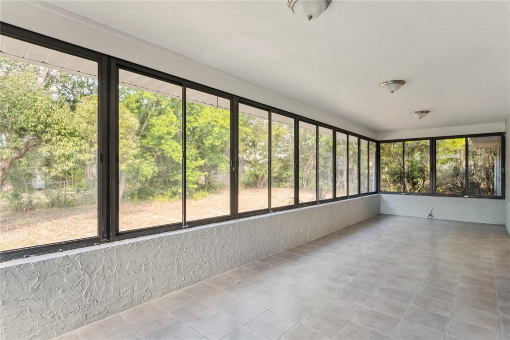 10237 Carrin Road Spring Hill, FL 34608 - Photo 27 of 39 a view of an empty room with a large window