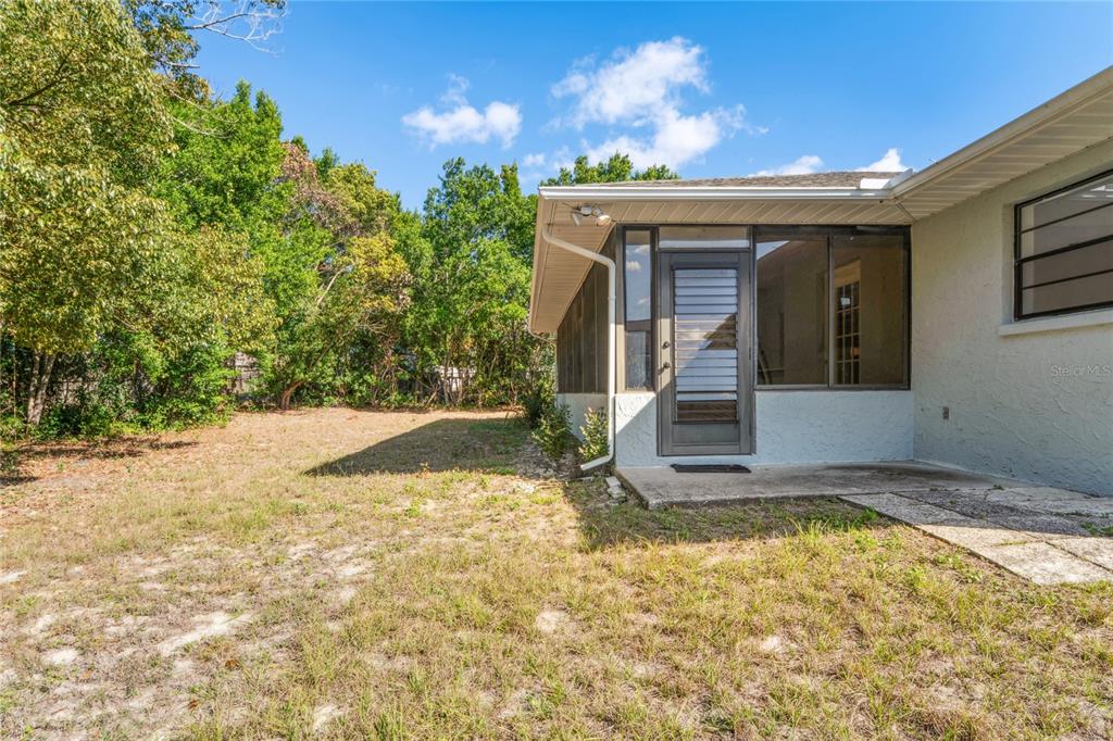 10237 Carrin Road Spring Hill, FL 34608 - Photo 31 of 39 a view of a house with a yard