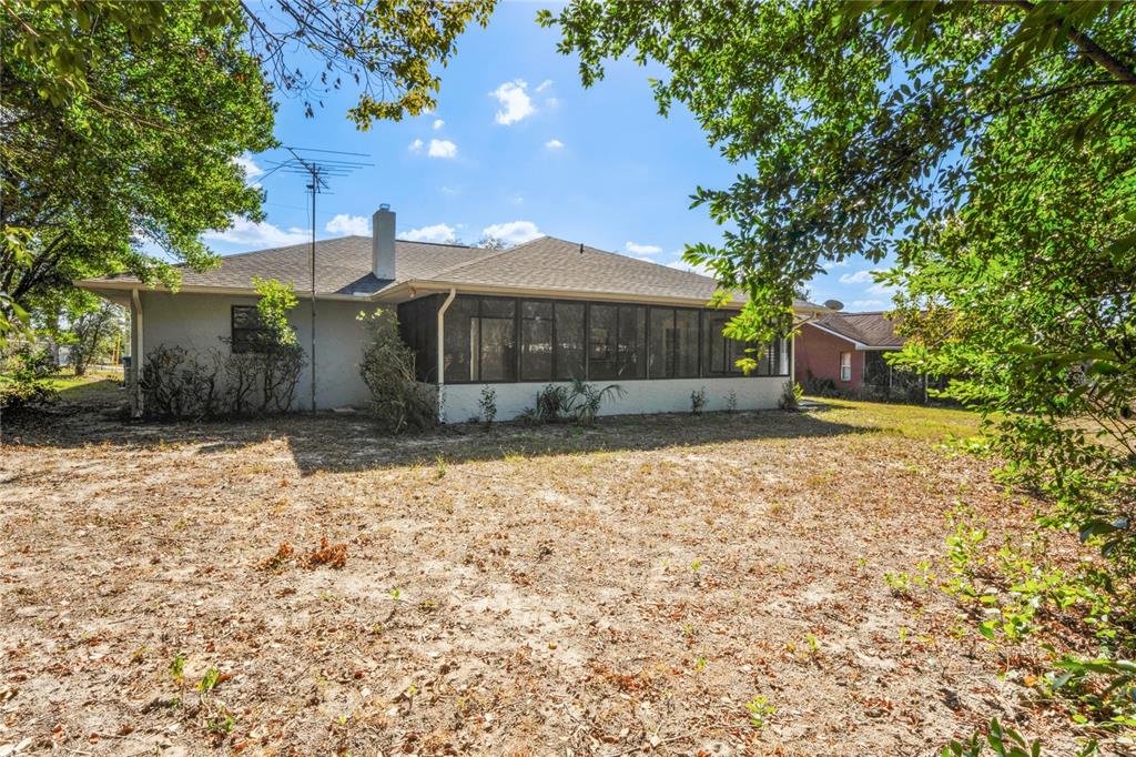 10237 Carrin Road Spring Hill, FL 34608 - Photo 33 of 39 a front view of a house with a yard