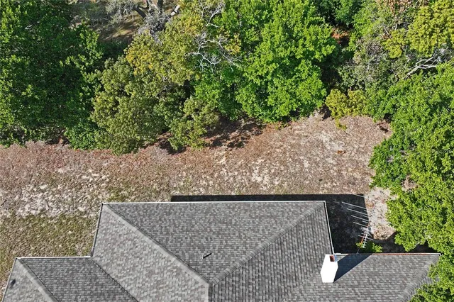 an aerial view of a house with outdoor space