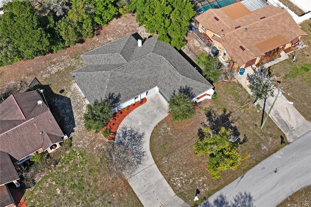 10237 Carrin Road Spring Hill, FL 34608 - Photo 37 of 39 an aerial view of a house with a yard and a large tree