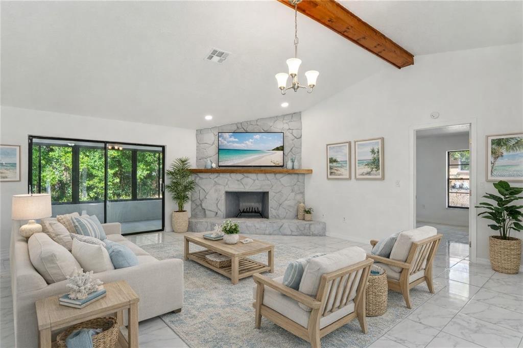 10237 Carrin Road Spring Hill, FL 34608 - Photo 4 of 39 a living room with furniture and a fireplace