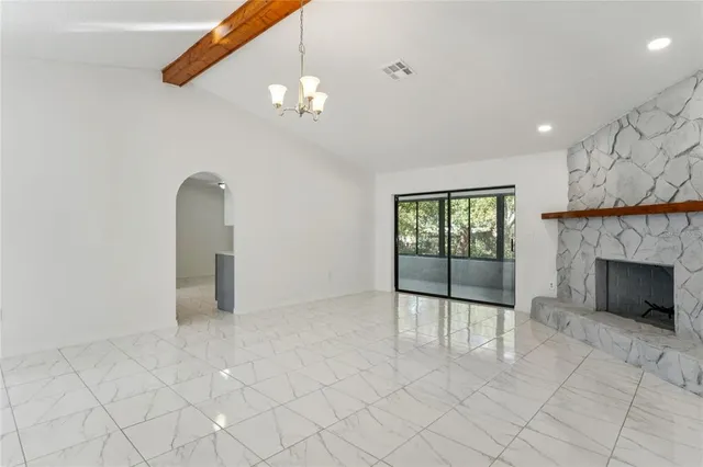 a view of an empty room with a fireplace