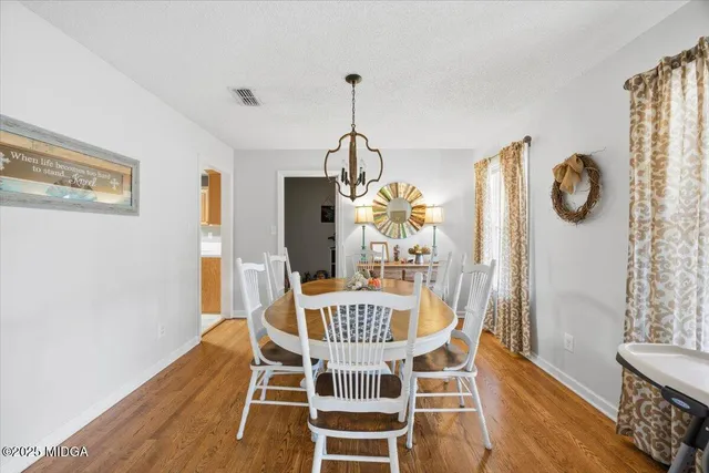 a view of a dining room with furniture window and wooden floor