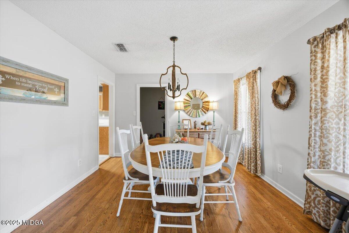 664 Aarons Circle Gray, GA 31032 - Photo 12 of 46 a view of a dining room with furniture window and wooden floor