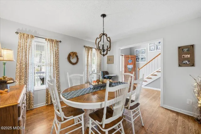 a dining room with furniture and window