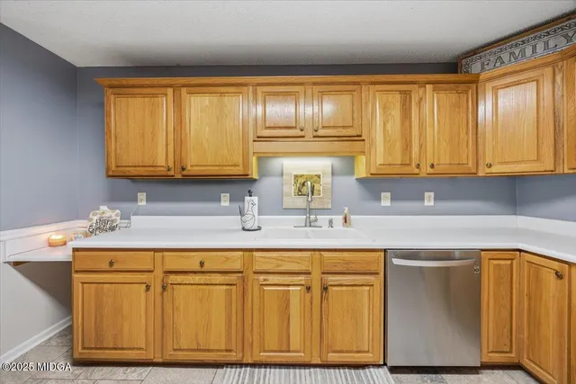 a kitchen with stainless steel appliances granite countertop wooden cabinets and a sink