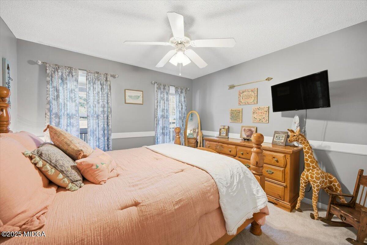 664 Aarons Circle Gray, GA 31032 - Photo 23 of 46 a bedroom with a bed and a flat screen tv