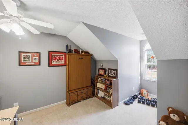 a view of a hallway with workspace and a window