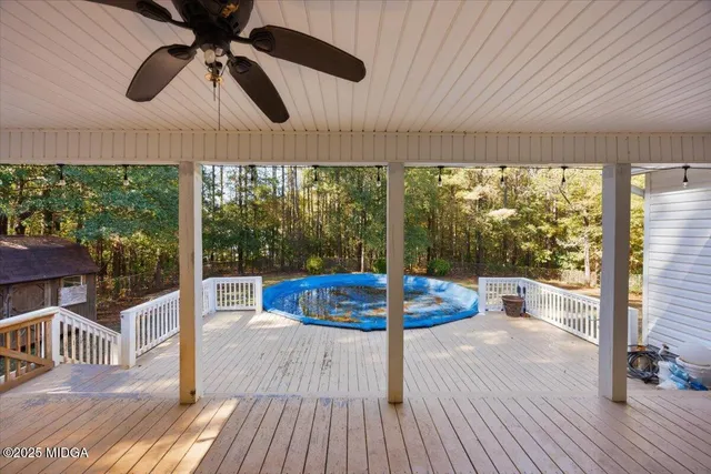 a dining room with wooden floor outdoor seating and windows