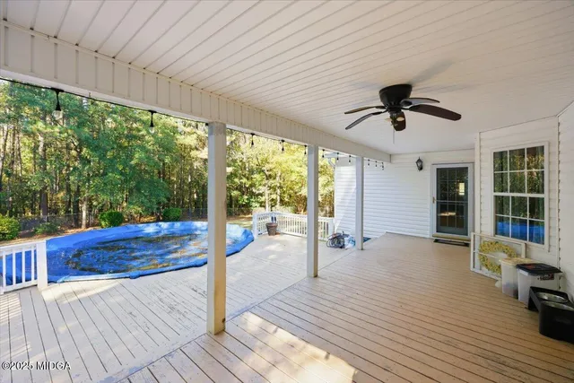 a view of a porch with wooden floor and outdoor space