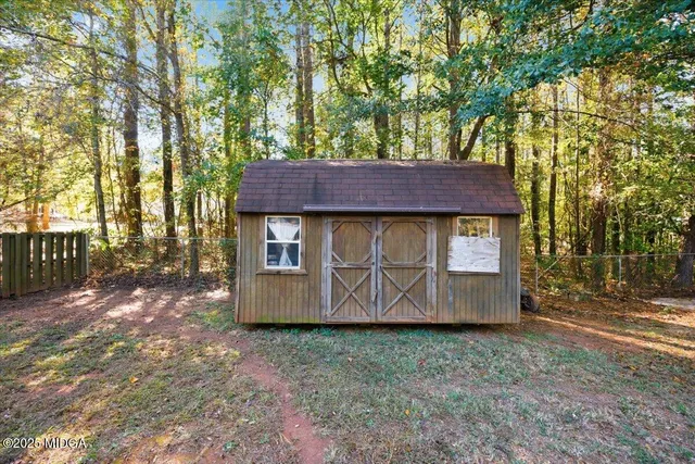 a wooden fence with some trees in the background