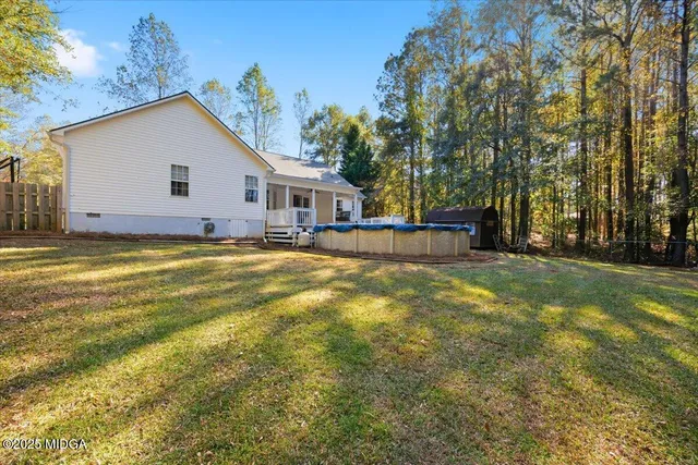 a view of a house with a yard and garage