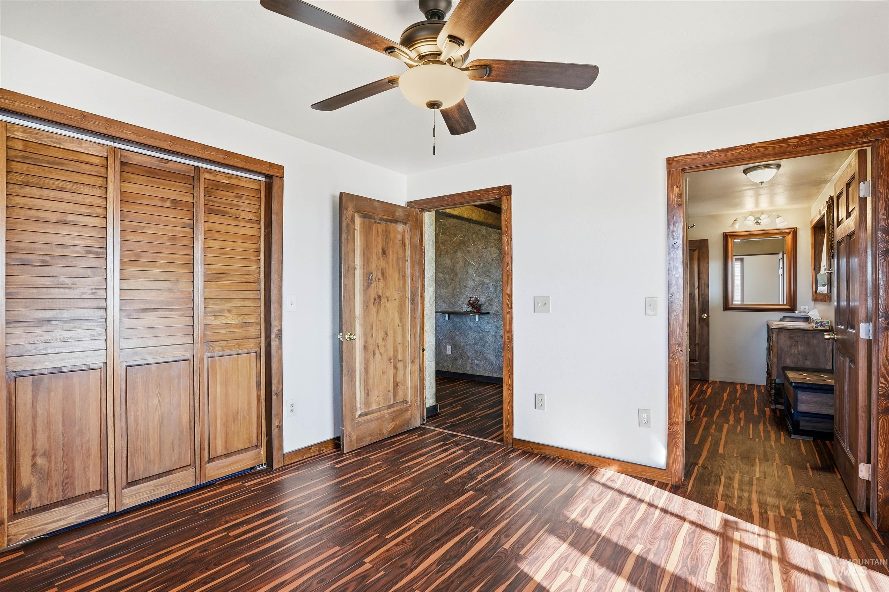 1252 Mesa Mesa, ID 83643 - Photo 14 of 50 Unfurnished bedroom with dark wood finished floors, a closet, and a ceiling fan