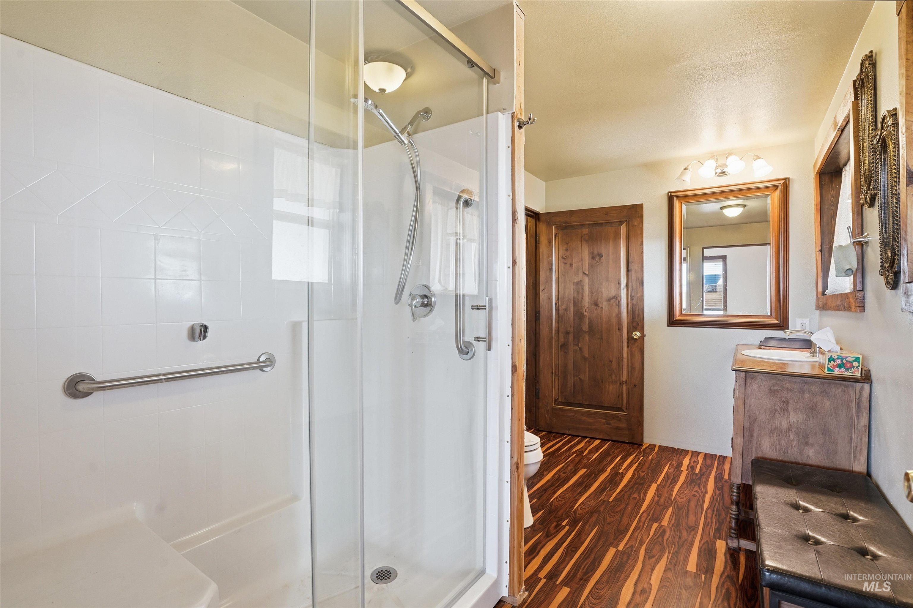 1252 Mesa Mesa, ID 83643 - Photo 16 of 50 Bathroom with vanity, a stall shower, and dark wood finished floors