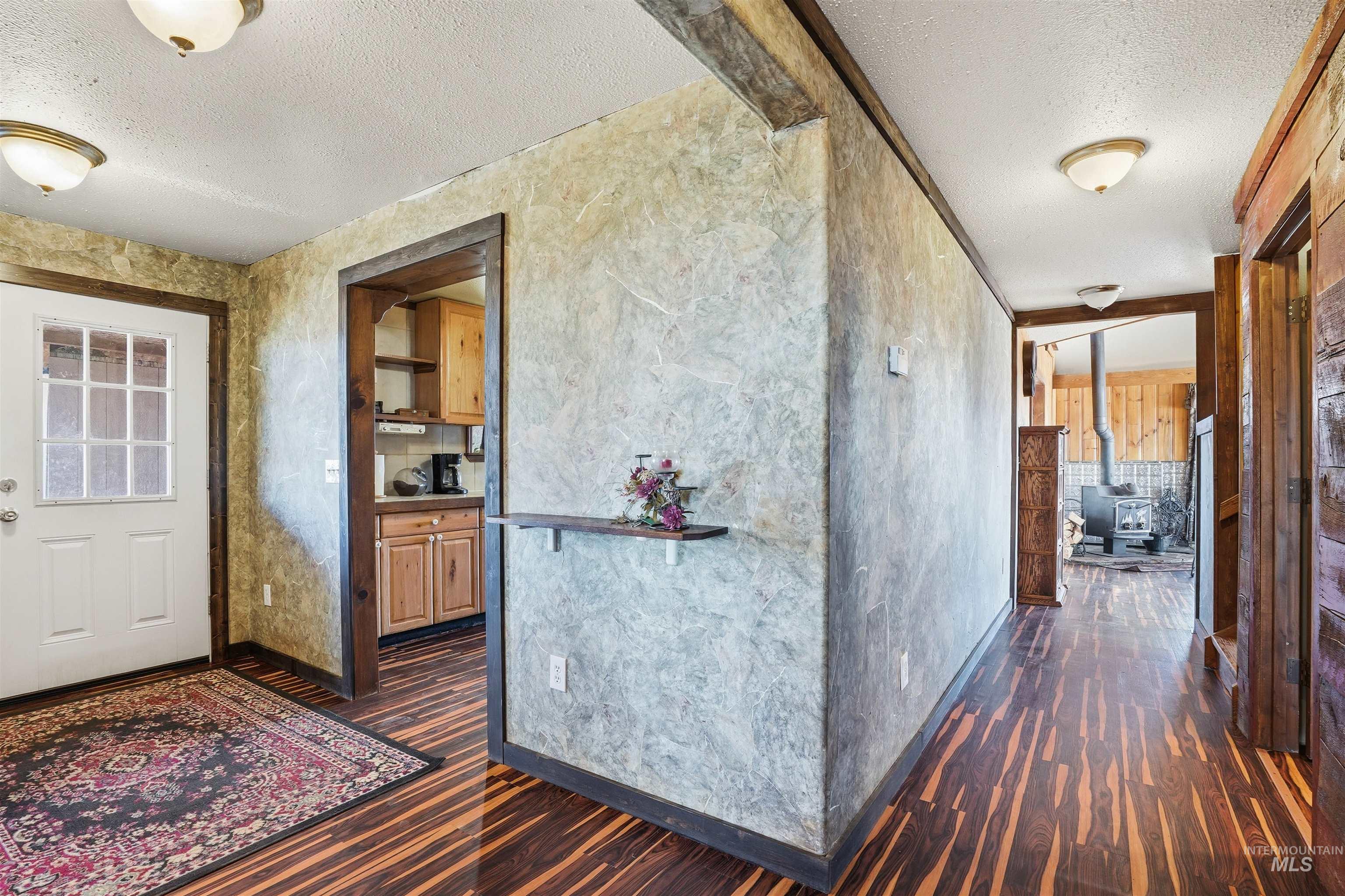 1252 Mesa Mesa, ID 83643 - Photo 19 of 50 Hallway featuring a textured ceiling and dark wood-type flooring