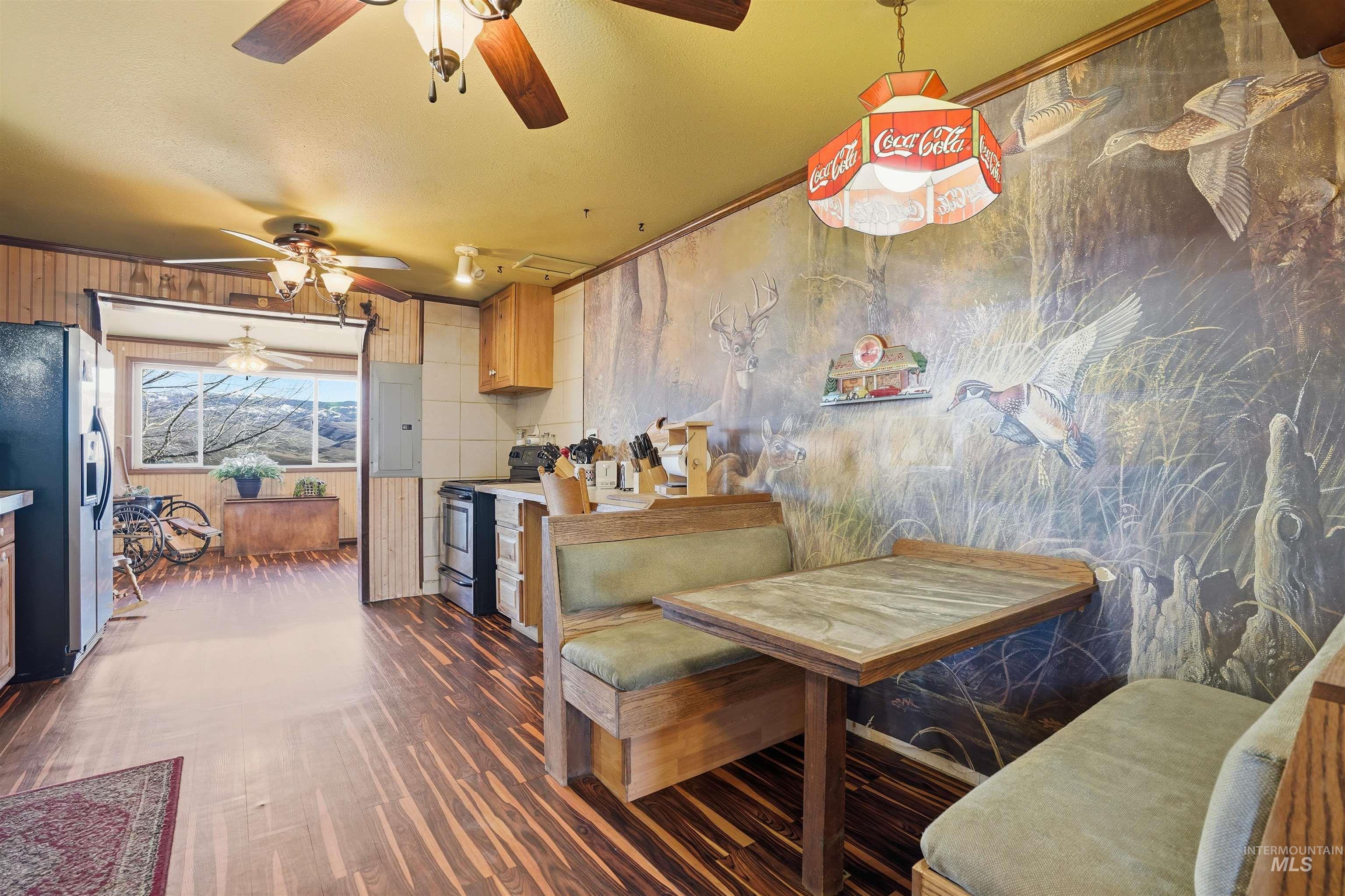 1252 Mesa Mesa, ID 83643 - Photo 8 of 50 Dining room featuring electric panel, dark wood-type flooring, ceiling fan, and crown molding
