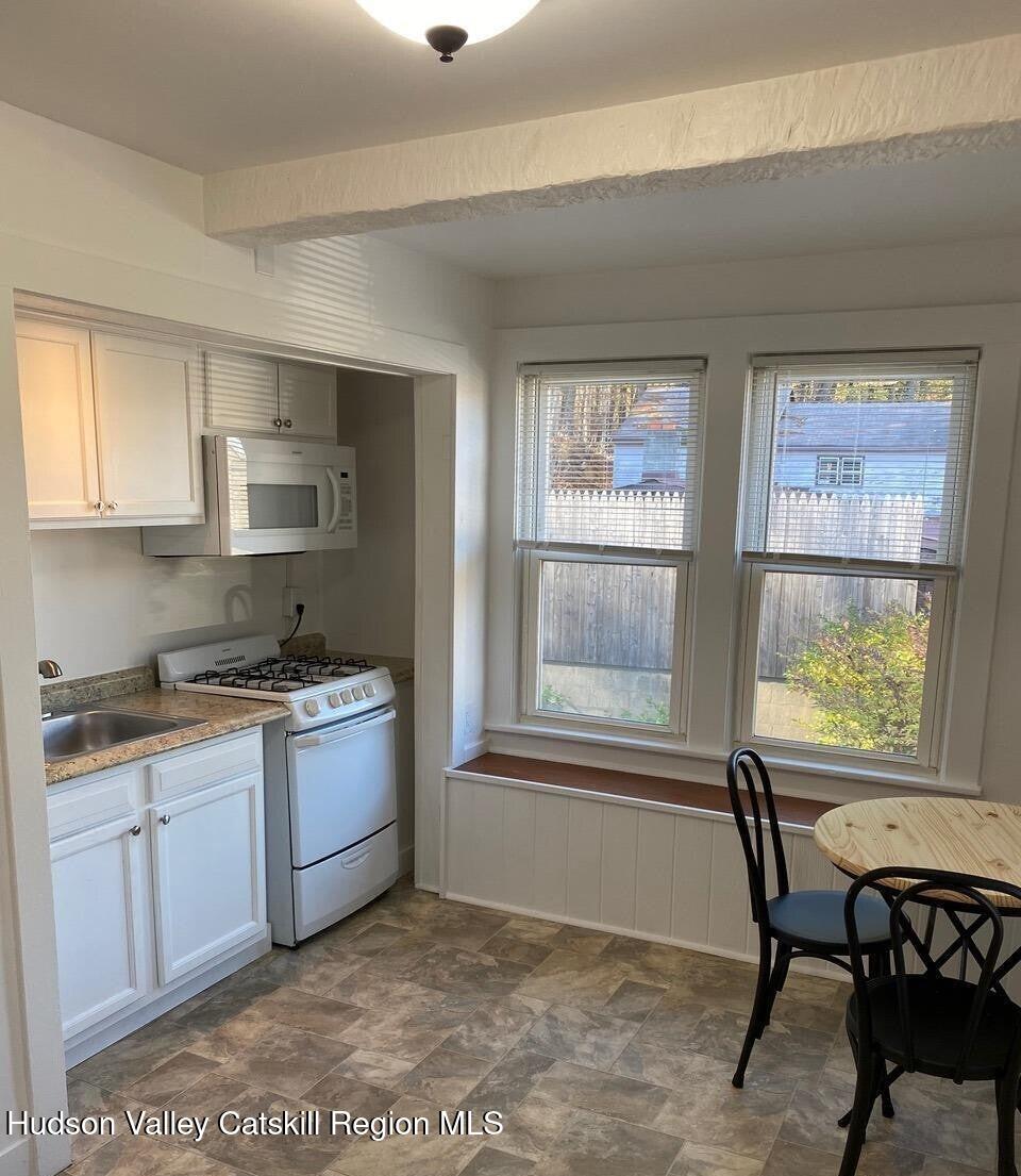 353 Main Street, Unit 2 Cairo, NY 12413 - Photo 5 of 12 a kitchen with stainless steel appliances granite countertop a stove a sink and a microwave