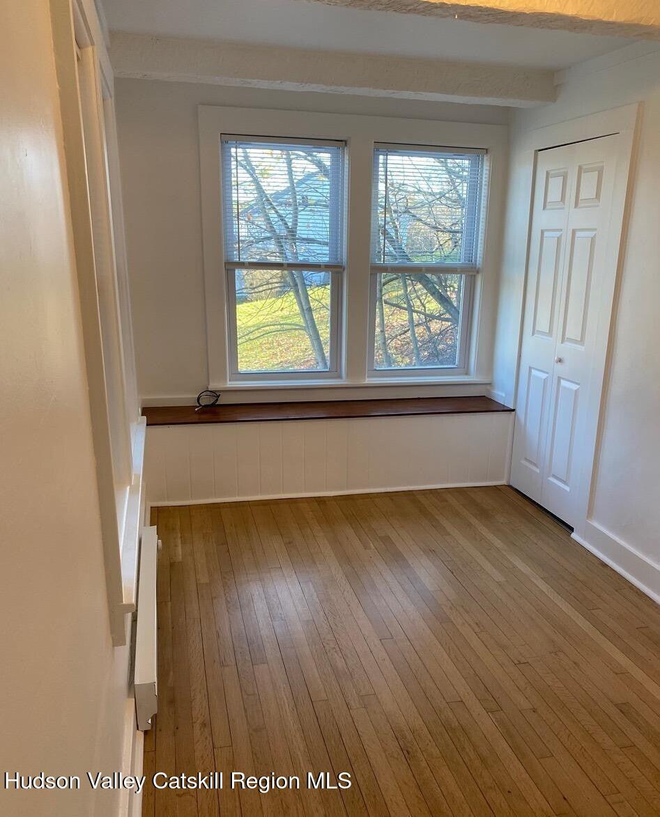 353 Main Street, Unit 2 Cairo, NY 12413 - Photo 10 of 12 an empty room with wooden floor and windows