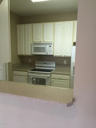 a kitchen with a cabinets and a oven
