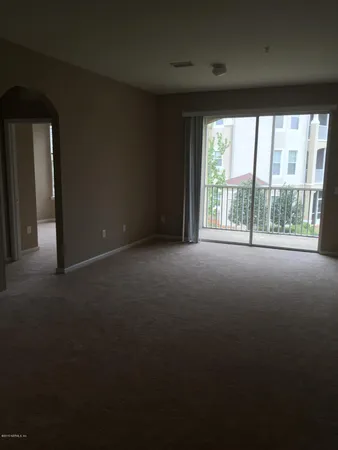 a view of empty room with large windows