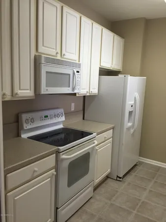 a kitchen with cabinets and a stove top oven