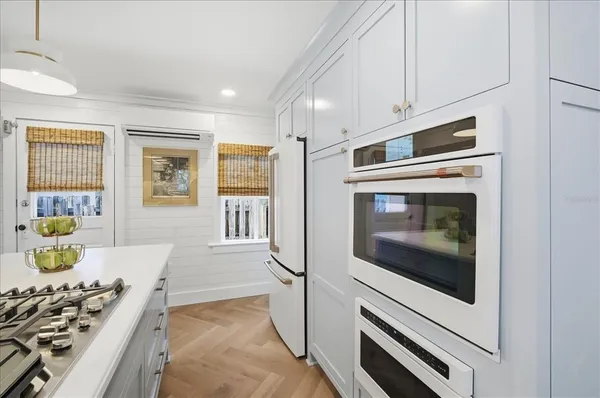 a kitchen with stainless steel appliances a stove microwave and refrigerator