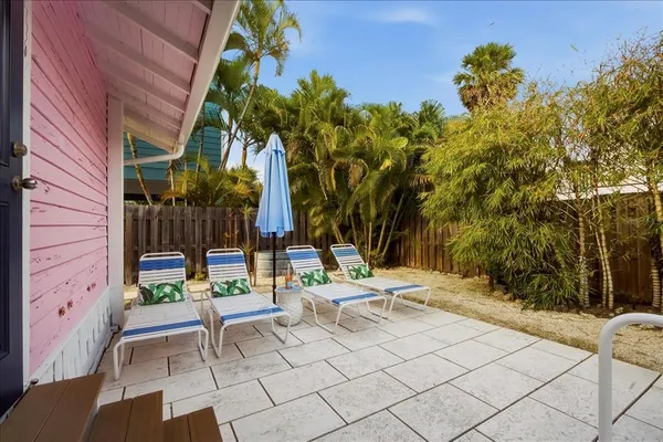 a view of backyard with swimming pool and outdoor seating